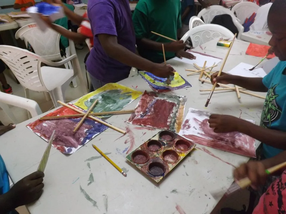 Hands working on a creative craft activity.