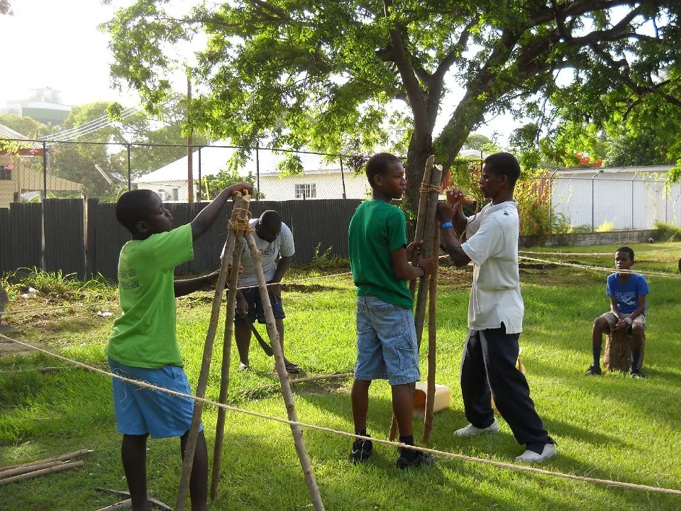 Scouts working on a pioneering structure at camp.