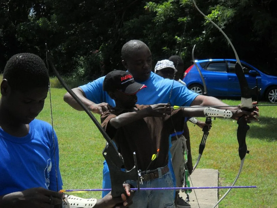 A Scout practising archery at camp.